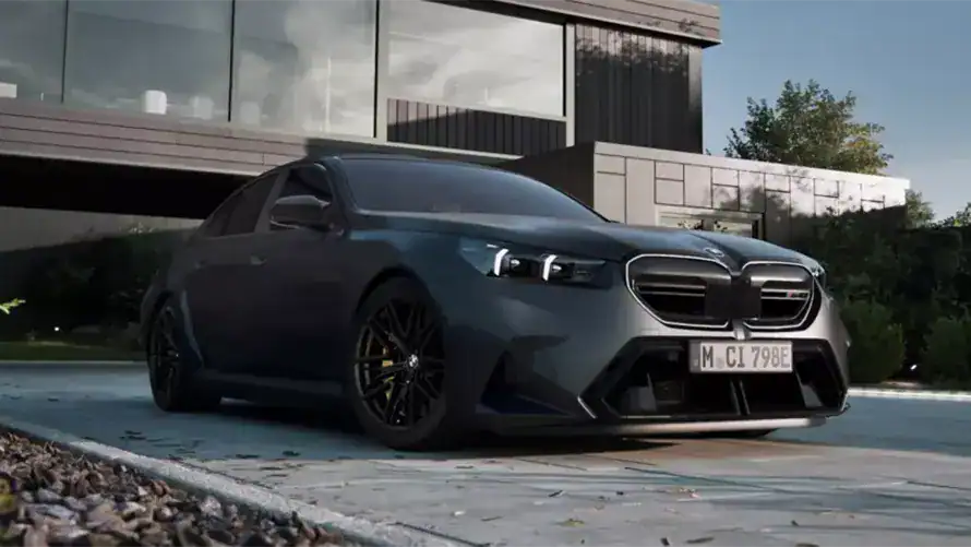 Dunkler BMW vor modernem Gebäude, seitliche Ansicht, tagsüber aufgenommen.